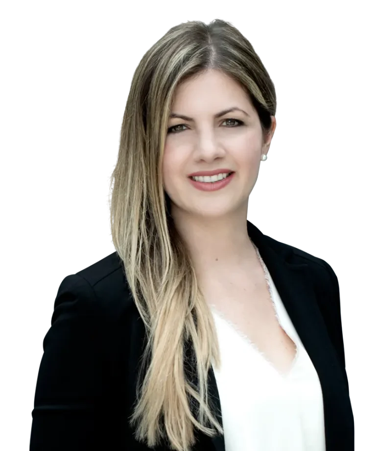 Woman with long blonde hair wearing a black blazer and white blouse, smiling.