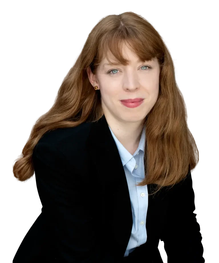 Woman with long hair in a black blazer and light blue shirt.