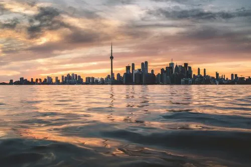 Toronto skyline at sunset viewed from across the water.