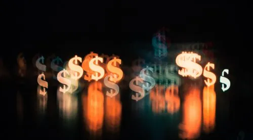Glowing, blurred dollar signs on a dark background.