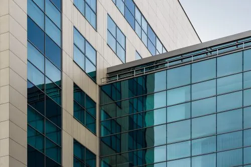 Modern glass and concrete building with intersecting angles.