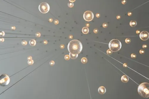 Numerous spherical lights hang from the ceiling, creating a star-like pattern.